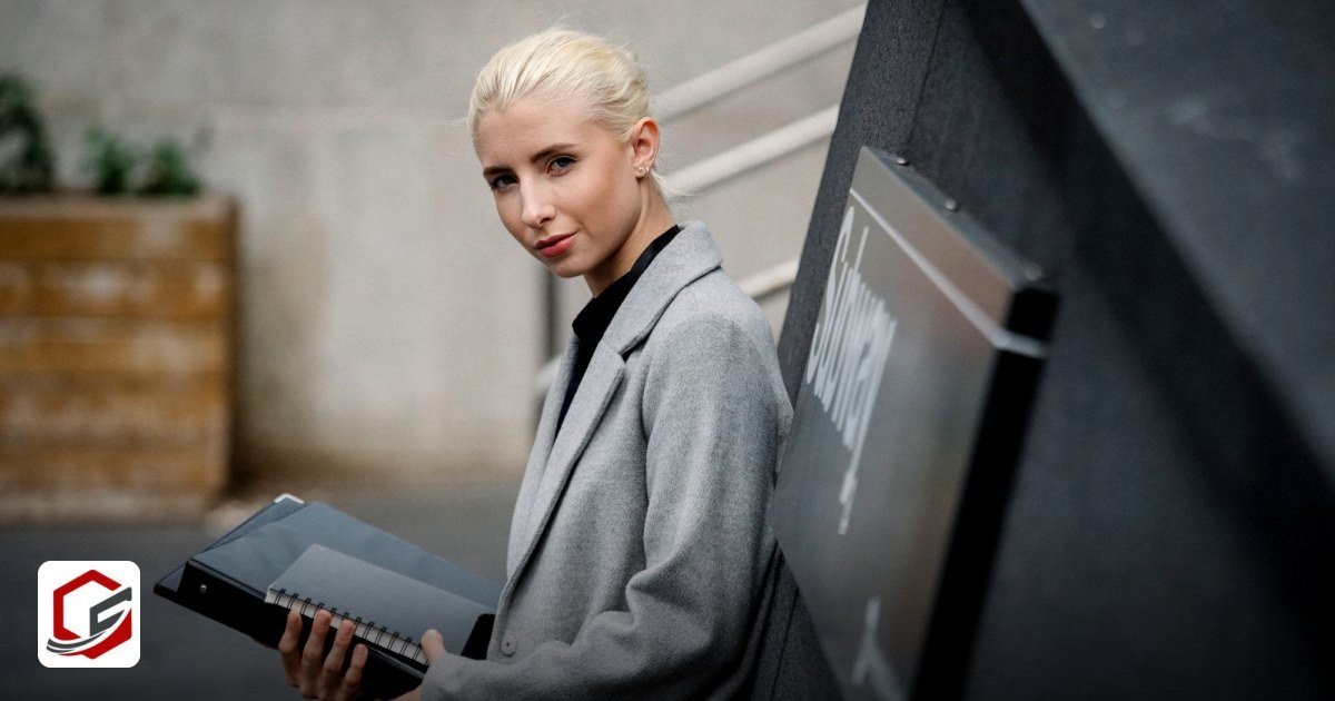 Free Zone Owner Residence Visa & Emirates ID Guide - side view attractive young businesswoman in gray coat standing